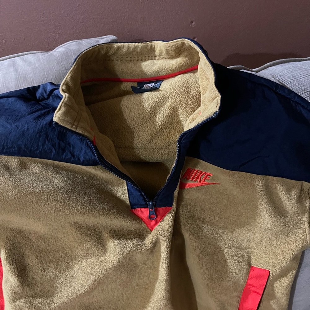 Blue, Orange, and tan crop pullover Nike track suit.